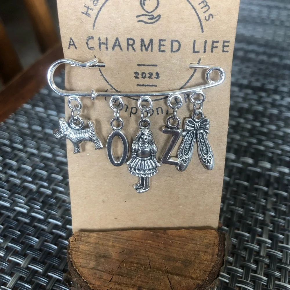 NWT, Handmade by A Charmed Life. Wizard of Oz Silver Charms/Silver 2” Pin